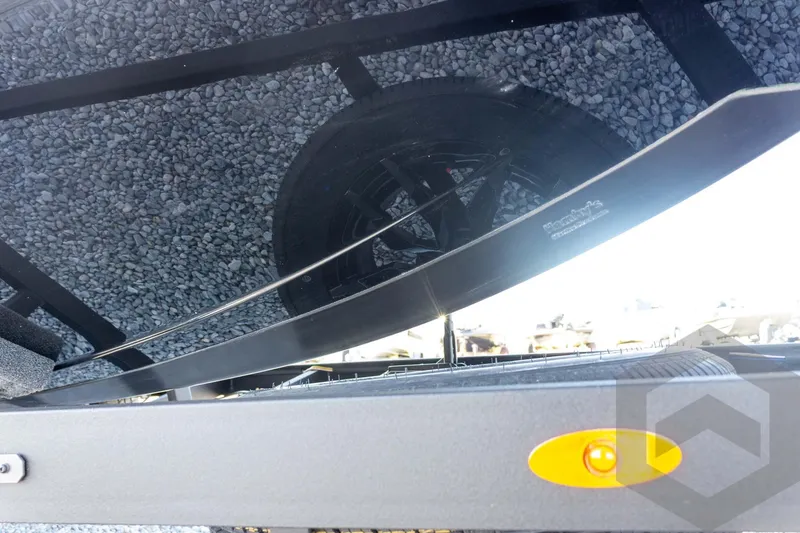 Slide: The Image of 2026 Vexus VXs20 boat trailer with reflective surface and gravel background. - 17