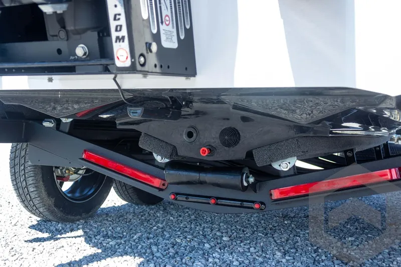 Slide: The Image of 2026 Vexus VXs20 boat trailer with red reflectors and black frame on gravel. - 23