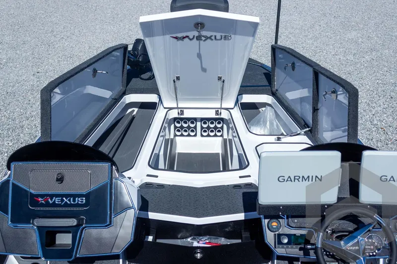 Slide: The Image of 2026 Vexus VXs20 boat interior with open storage compartments and Garmin displays. - 28