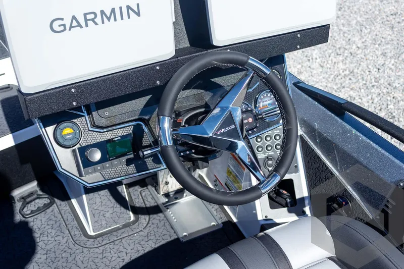 Slide: The Image of 2026 Vexus VXs20 boat dashboard with Garmin electronics and sleek steering wheel design. - 39