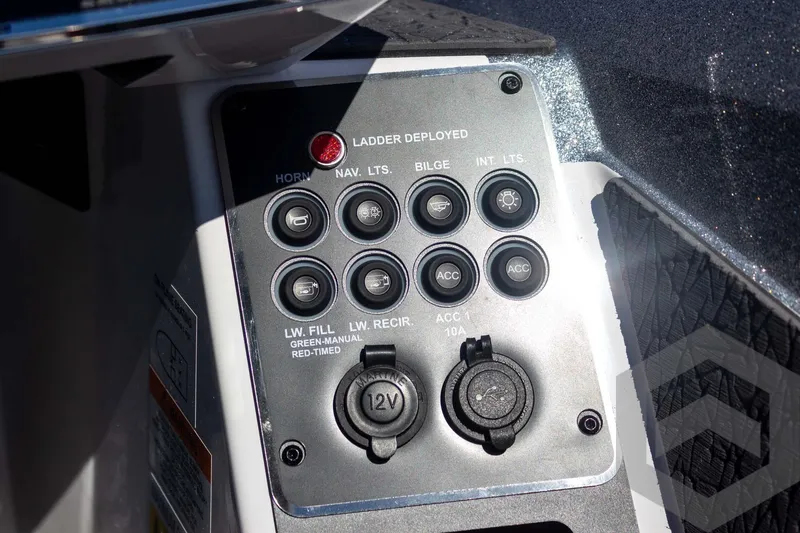 Slide: The Image of Control panel of 2026 Vexus VXs20 boat with various switches and 12V outlet. - 42