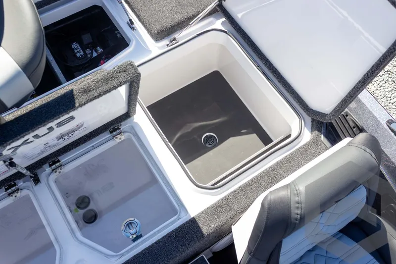 Slide: The Image of 2026 Vexus VXs20 boat storage compartments with open lids and seating area. - 49