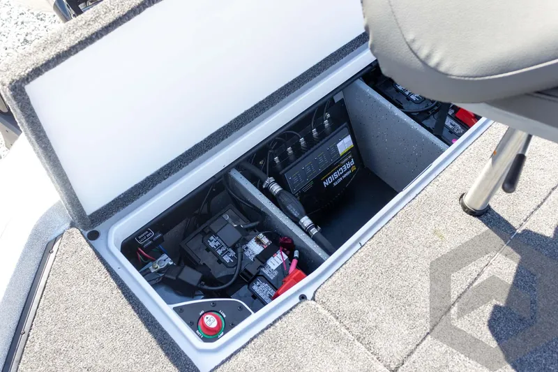 Slide: The Image of 2026 Vexus VXs20 boat battery compartment with precision charger and wiring. - 51