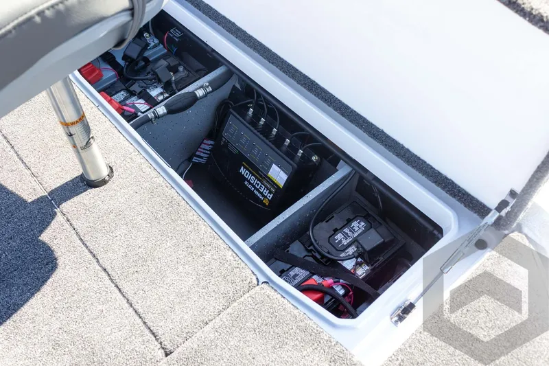 Slide: The Image of 2026 Vexus VXs20 boat battery compartment with precision charger and wiring. - 52