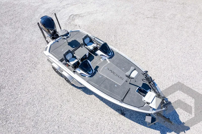 Slide: The Image of 2026 Vexus VXs20 boat on gravel, top view, showcasing sleek design and seating arrangement. - 63