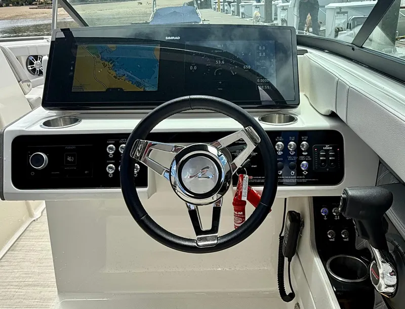 Slide: The Image of 2020 Sea Ray SLX 280 dashboard with steering wheel and navigation display. - 10