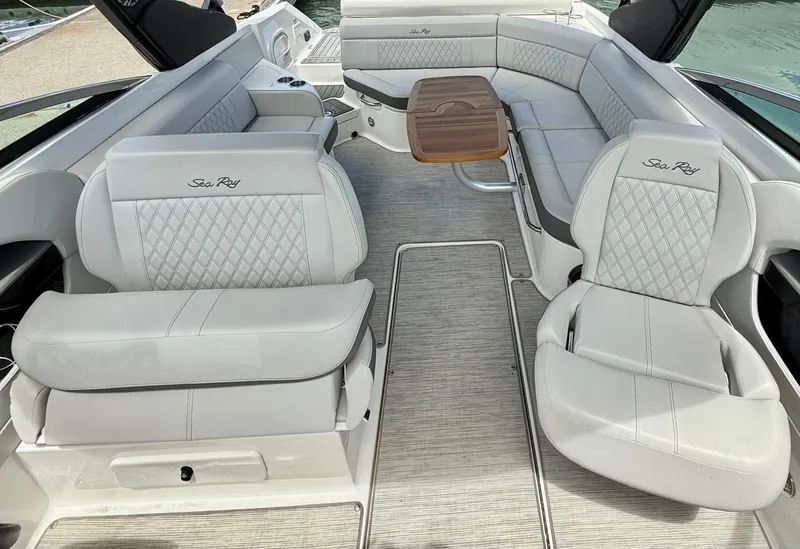 Slide: The Image of 2020 Sea Ray SLX 280 boat interior with luxurious seating and wooden table. - 19