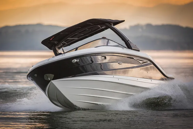 Slide: The Image of Manufacturer Provided Image: 2020 Sea Ray SLX 280 boat cruising on water at sunset. - 2