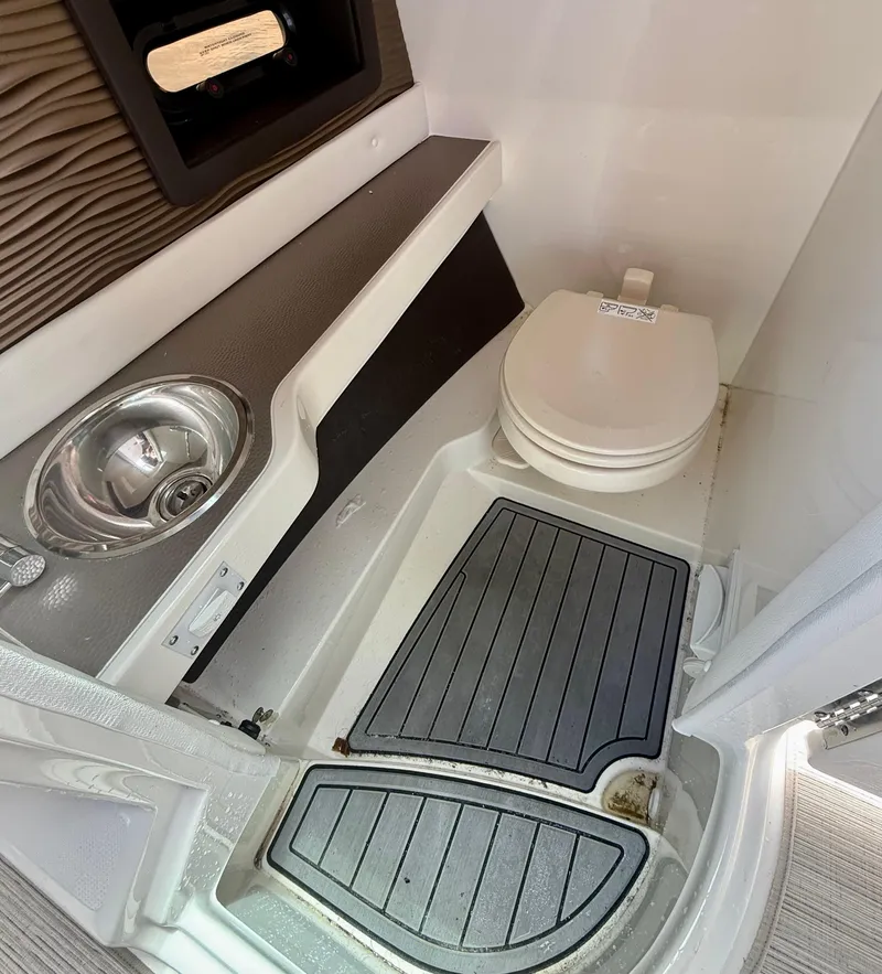 Slide: The Image of 2020 Sea Ray SLX 280 boat interior with sink and toilet. - 20