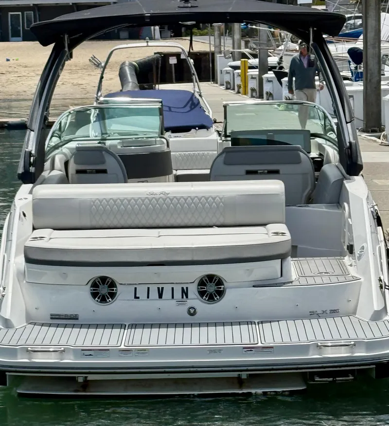 Slide: The Image of 2020 Sea Ray SLX 280 boat docked, rear view with seating and "LIVIN" nameplate. - 22