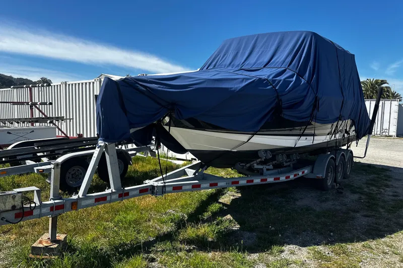 Slide: The Image of 2020 Sea Ray SLX 280 boat covered on a trailer, parked outdoors. - 32