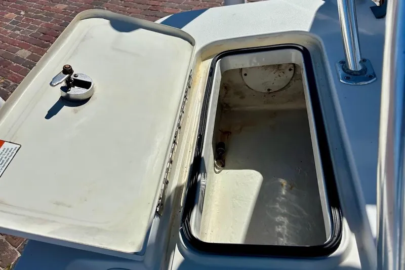 Slide: The Image of Open storage compartment on a 2009 Ranger Banshee boat, showing interior details. - 16