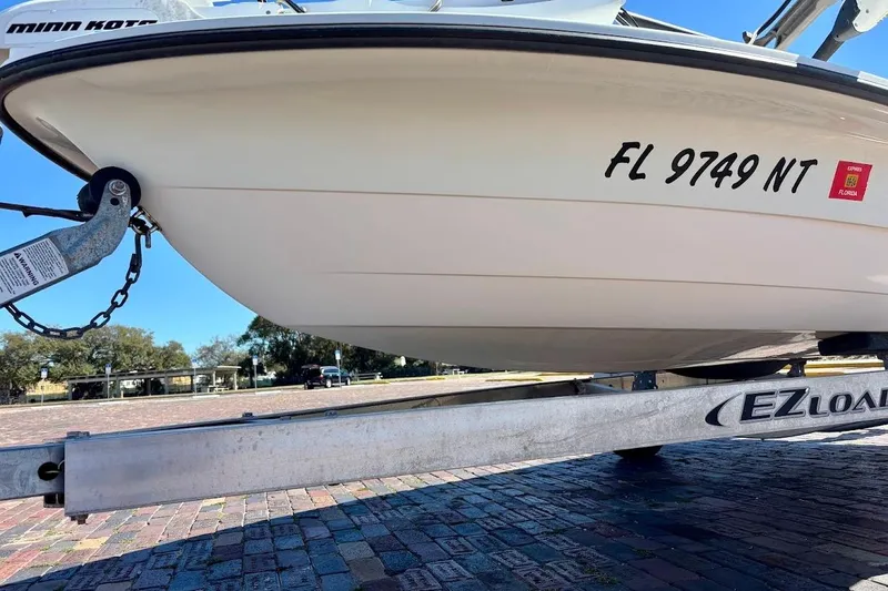 Slide: The Image of 2009 Ranger Banshee boat on EZ Loader trailer, Florida registration visible. - 4