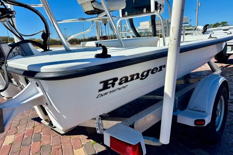 Slide: The Image of 2009 Ranger Banshee boat on trailer, parked on brick pavement. - 6