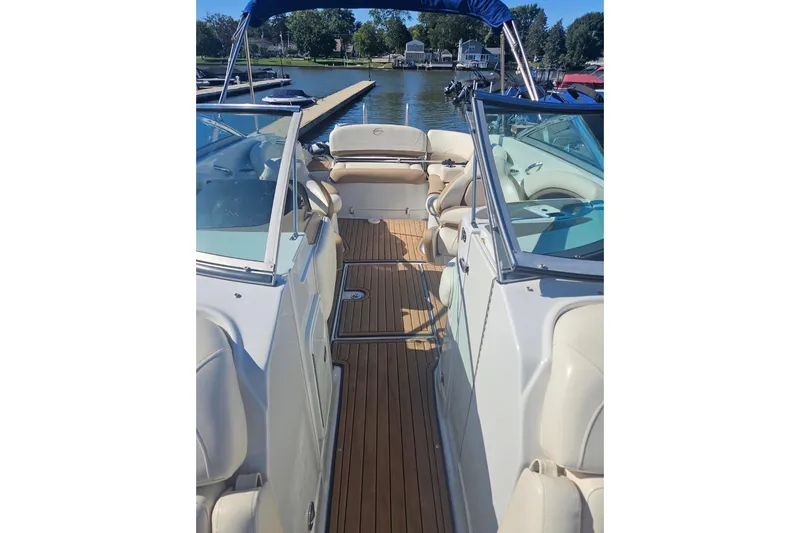 Slide: The Image of 2017 Crownline Eclipse E4 boat interior with tan seating and wooden deck. - 15
