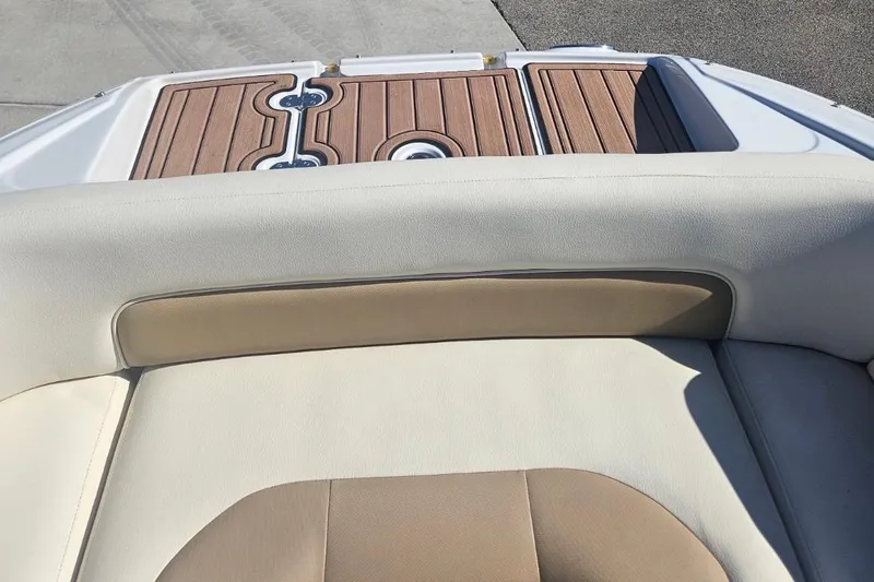 Slide: The Image of 2017 Crownline Eclipse E4 boat interior with beige seating and wooden deck. - 16