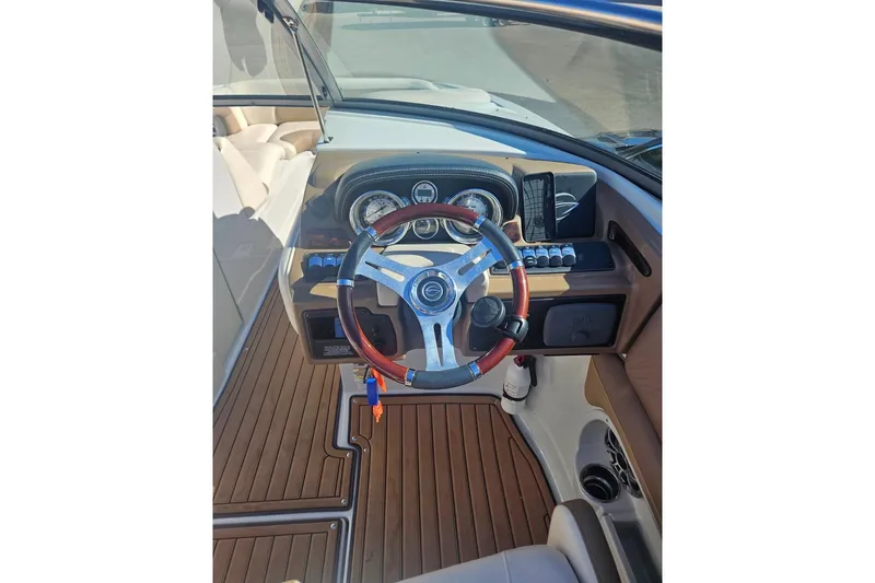 Slide: The Image of 2017 Crownline Eclipse E4 boat dashboard with steering wheel and controls. - 17
