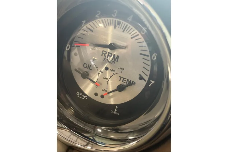 Slide: The Image of Close-up of 2017 Crownline Eclipse E4 RPM gauge with oil and temperature indicators. - 21
