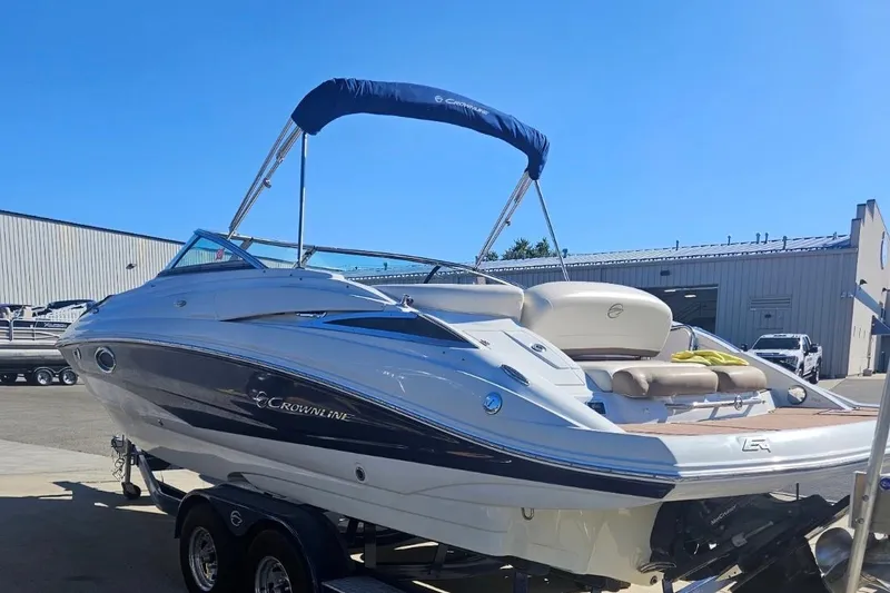 Slide: The Image of 2017 Crownline Eclipse E4 boat on trailer, parked outdoors under clear blue sky. - 3