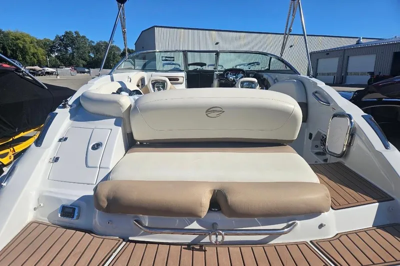 Slide: The Image of 2017 Crownline Eclipse E4 boat interior with seating and dashboard, docked outdoors. - 4