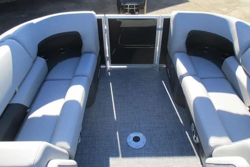 Slide: The Image of 2026 Sun Tracker Party Barge 22 DLX interior with gray seating and open deck space. - 10