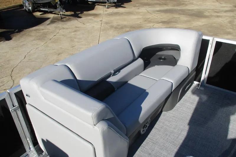 Slide: The Image of 2026 Sun Tracker Party Barge 22 DLX with comfortable gray seating and cup holder. - 14