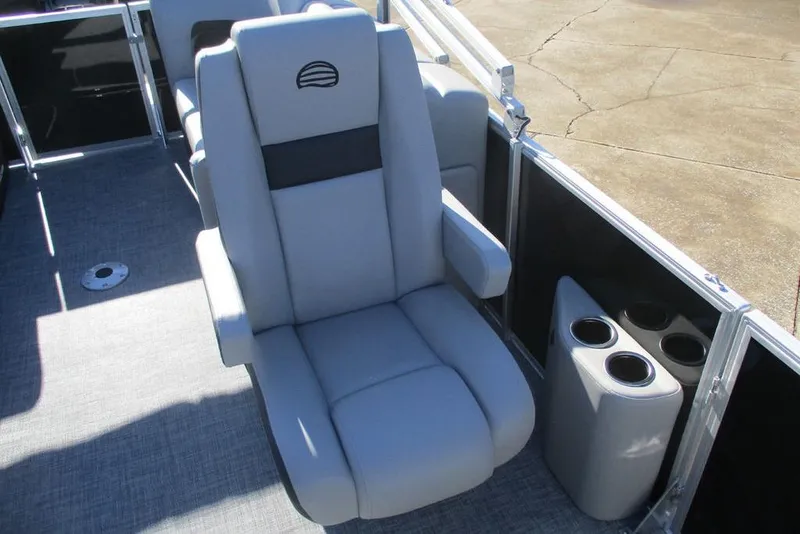 Slide: The Image of 2026 Sun Tracker Party Barge 22 DLX interior with plush seating and cup holders. - 6