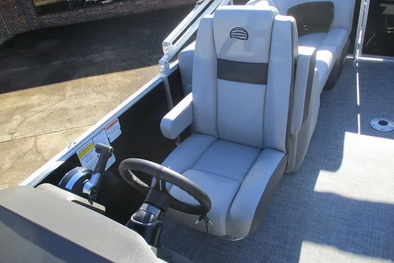 Slide: The Image of 2026 Sun Tracker Party Barge 22 DLX interior with captain's chair and steering wheel. - 8