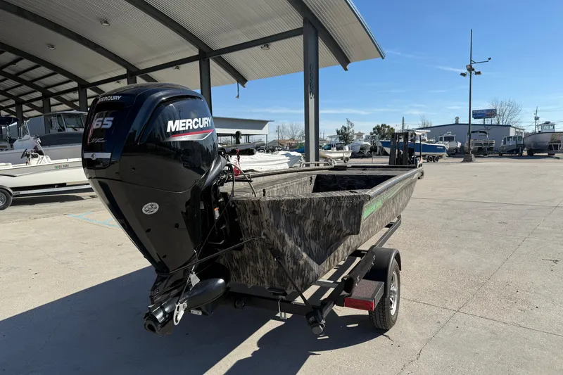 Slide: The Image of 2024 Havoc River Rat 1756 boat with Mercury 65 engine in a marina setting. - 8