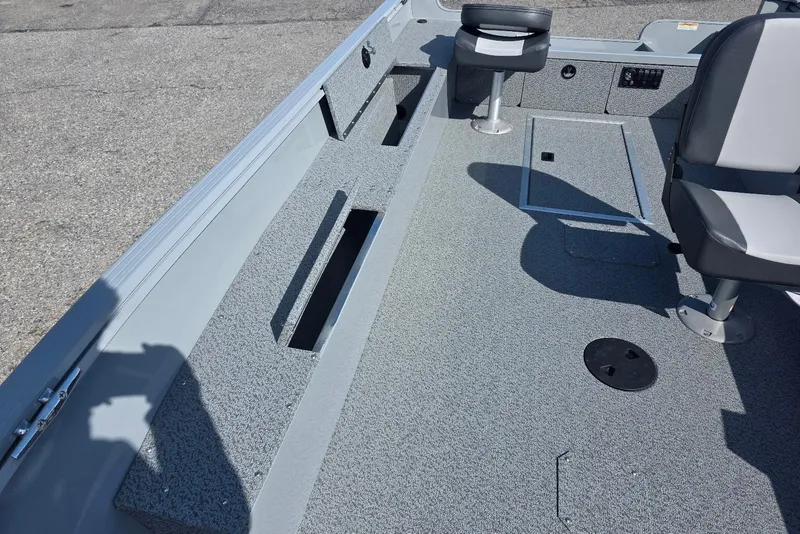 Slide: The Image of 2026 Smoker Craft Freedom 160 TL boat interior with seating and storage compartments. - 13