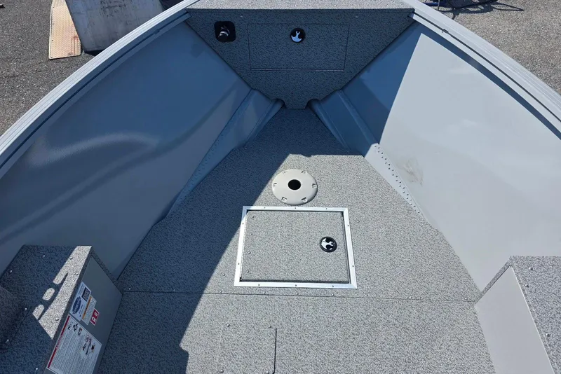 Slide: The Image of 2026 Smoker Craft Freedom 160 TL boat interior, featuring a spacious, carpeted deck. - 8