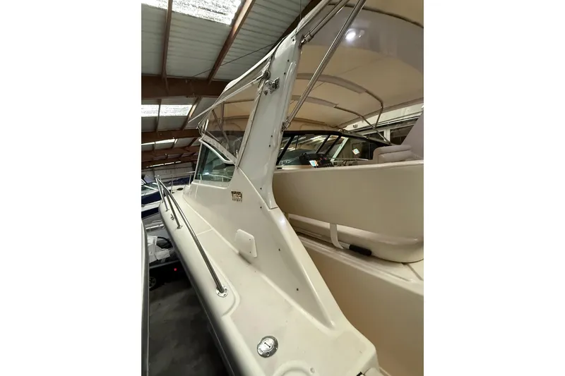 Slide: The Image of 1998 Tiara Yachts 3500 Open, side view in covered storage, showcasing sleek design. - 10
