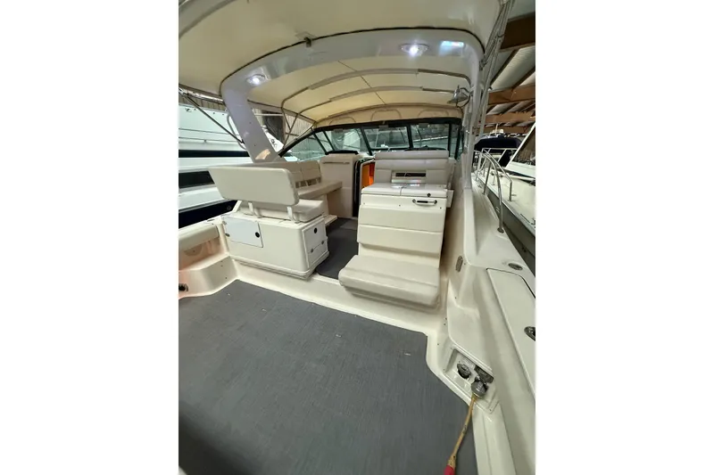 Slide: The Image of 1998 Tiara Yachts 3500 Open interior with seating and helm, under covered dock. - 15