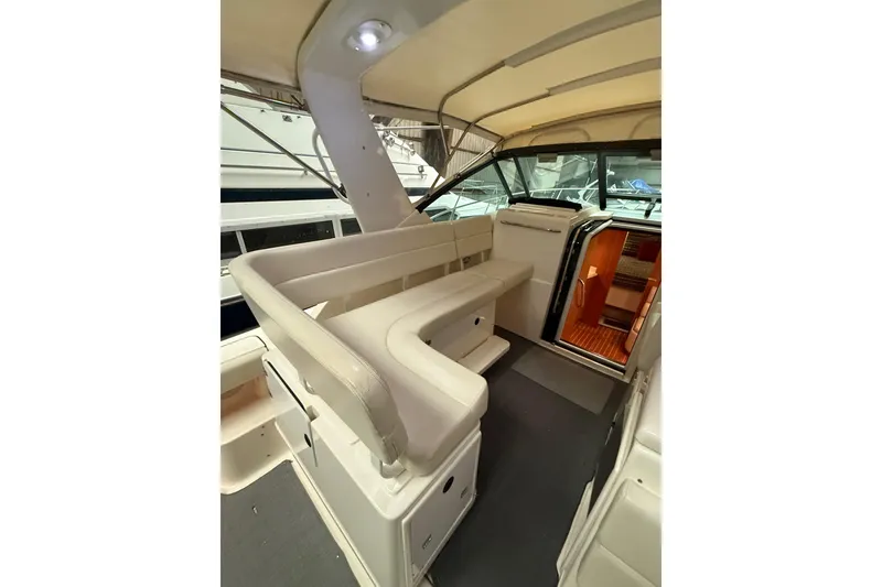 Slide: The Image of 1998 Tiara Yachts 3500 Open interior with white seating and cabin entrance. - 18