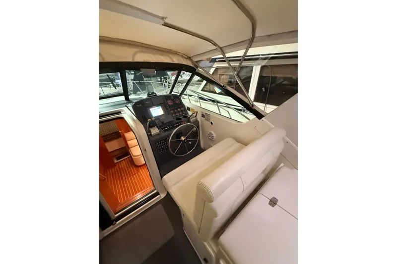 Slide: The Image of 1998 Tiara Yachts 3500 Open cockpit with steering wheel and navigation controls. - 21