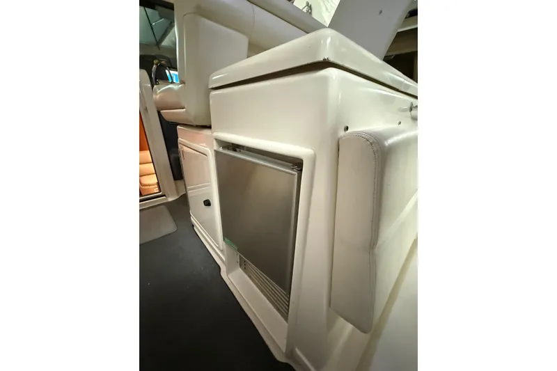 Slide: The Image of 1998 Tiara Yachts 3500 Open interior with built-in refrigerator and seating. - 23