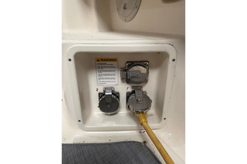 Slide: The Image of 1998 Tiara Yachts 3500 Open electrical panel with warning label and power connections. - 25