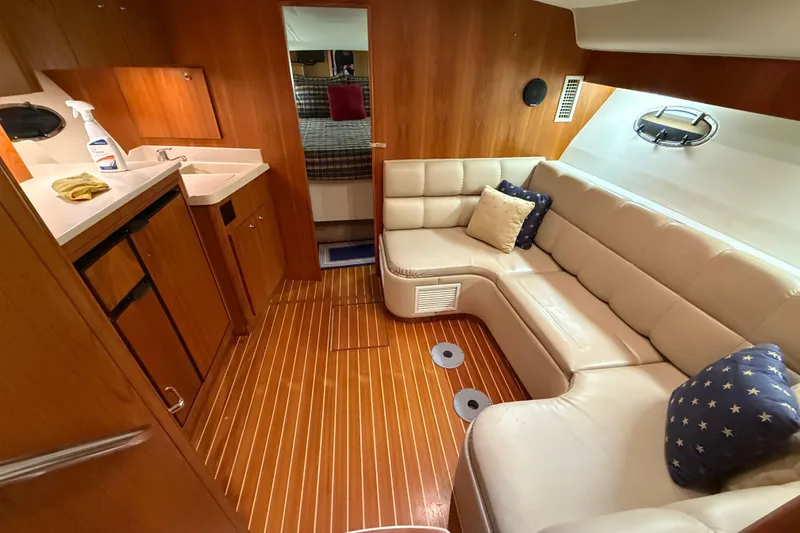 Slide: The Image of Luxurious interior of 1998 Tiara Yachts 3500 Open with leather seating and wooden flooring. - 26