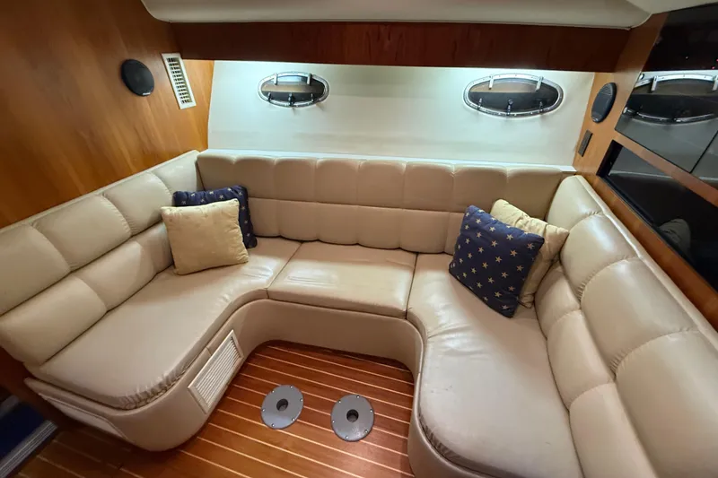 Slide: The Image of Luxurious interior of 1998 Tiara Yachts 3500 Open with plush seating and decorative pillows. - 27
