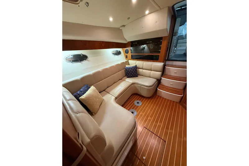 Slide: The Image of Luxurious interior of 1998 Tiara Yachts 3500 Open with plush seating and wooden flooring. - 28
