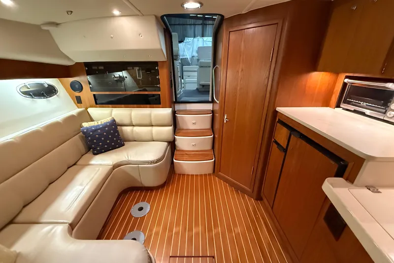Slide: The Image of Luxurious interior of 1998 Tiara Yachts 3500 Open with leather seating and wooden cabinetry. - 29