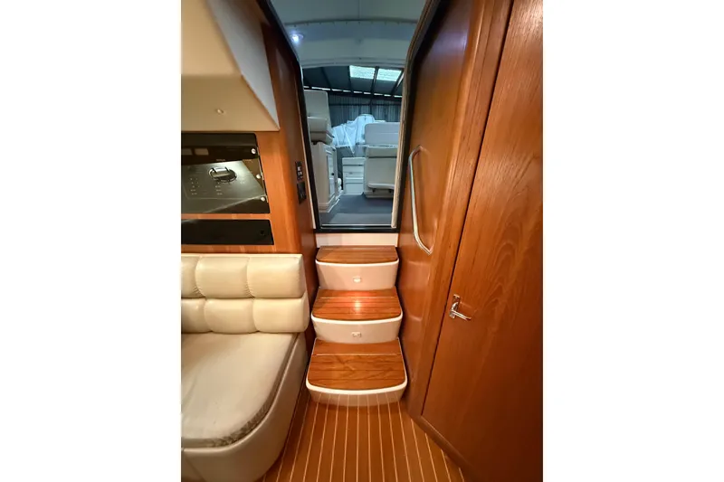 Slide: The Image of Interior of 1998 Tiara Yachts 3500 Open, featuring wooden steps and seating area. - 30