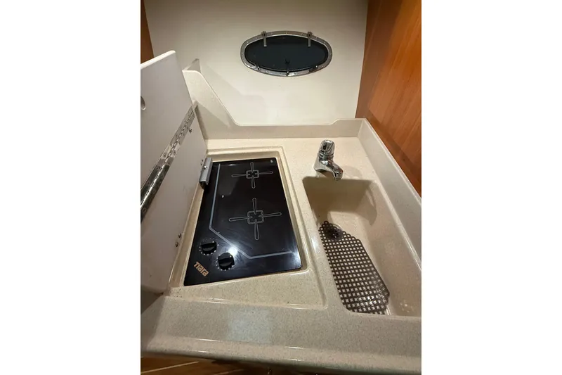 Slide: The Image of 1998 Tiara Yachts 3500 Open galley with stove and sink. - 36