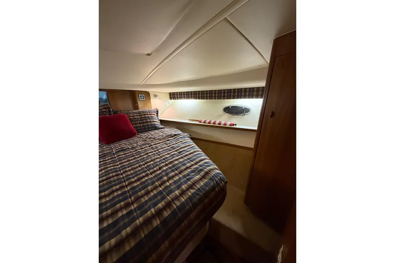 Slide: The Image of 1998 Tiara Yachts 3500 Open cabin with plaid bedding and cozy interior. - 39