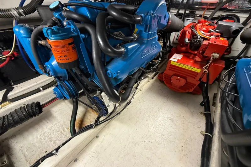 Slide: The Image of Engine room of a 1998 Tiara Yachts 3500 Open, featuring blue and red machinery. - 43