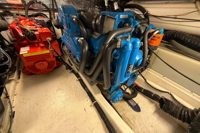 Slide: The Image of Engine room of a 1998 Tiara Yachts 3500 Open, featuring blue and red machinery. - 44