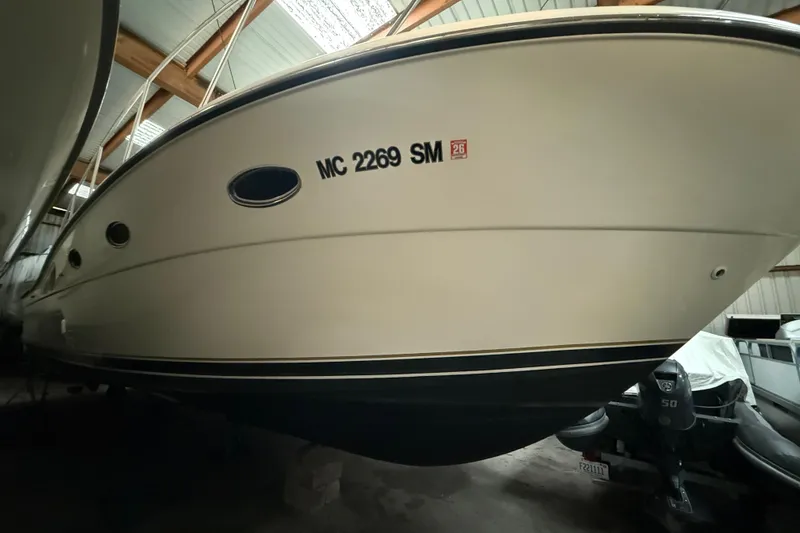 Slide: The Image of 1998 Tiara Yachts 3500 Open boat in storage, side view with registration number. - 45