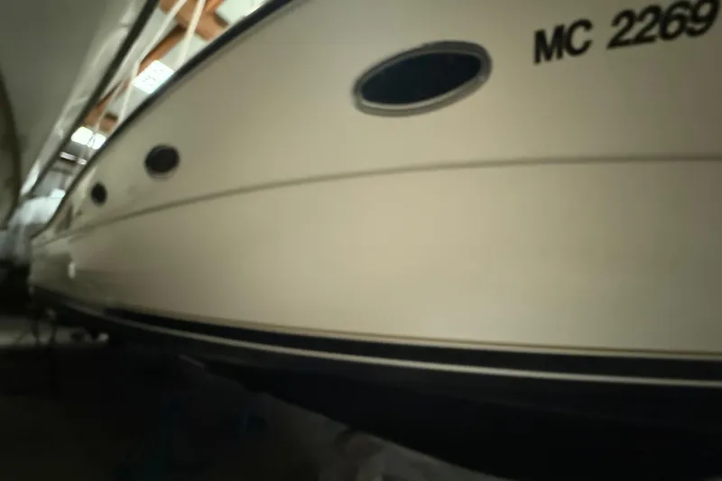 Slide: The Image of 1998 Tiara Yachts 3500 Open boat in storage, side view with registration number. - 46