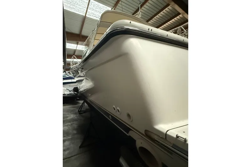 Slide: The Image of 1998 Tiara Yachts 3500 Open in storage, showcasing sleek hull design. - 47