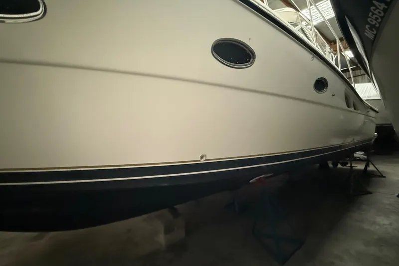 Slide: The Image of 1998 Tiara Yachts 3500 Open in storage, showcasing sleek hull design. - 49